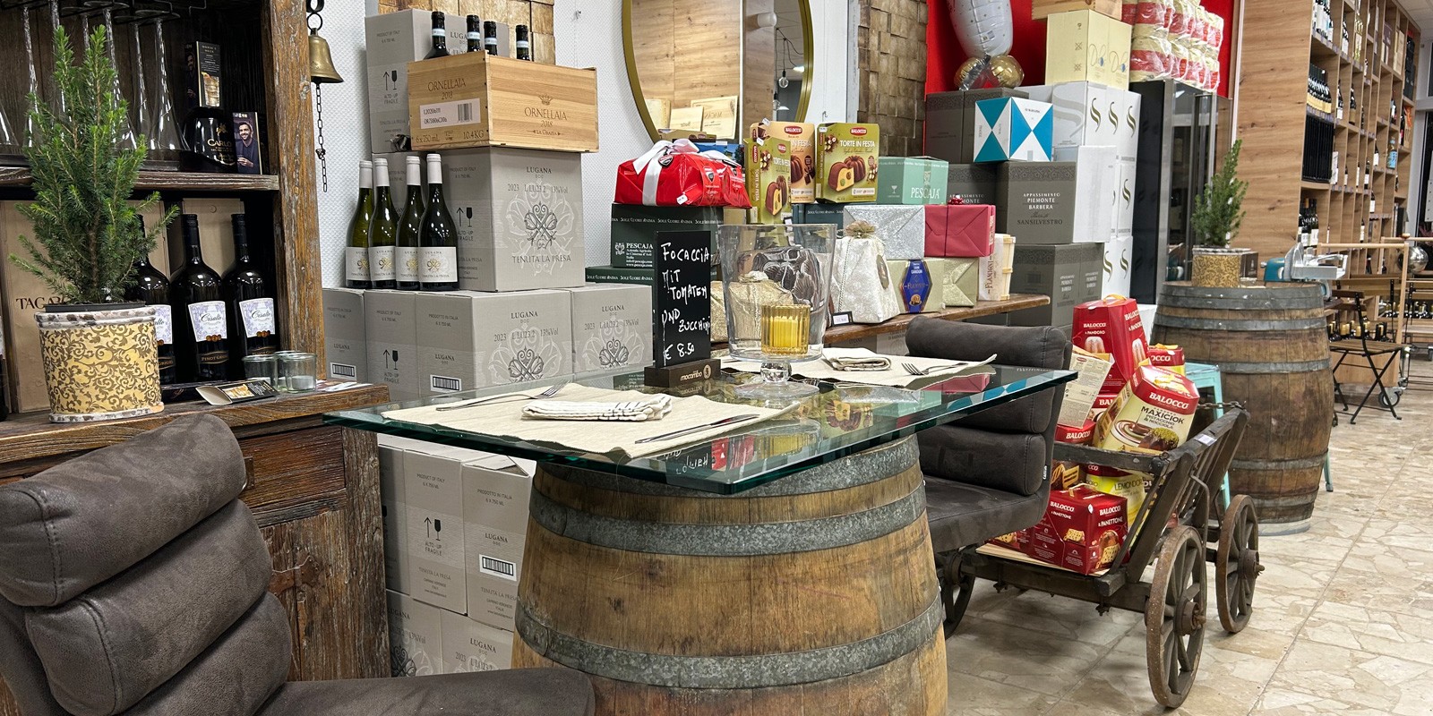 Ein Blick in das Weinangebot, im Vordergrund ein altes Holzfass